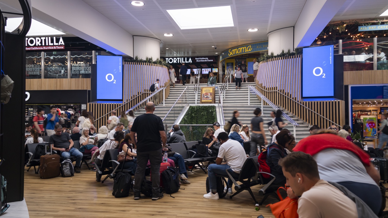 Digital 6-sheet screen in an airport terminal walkway