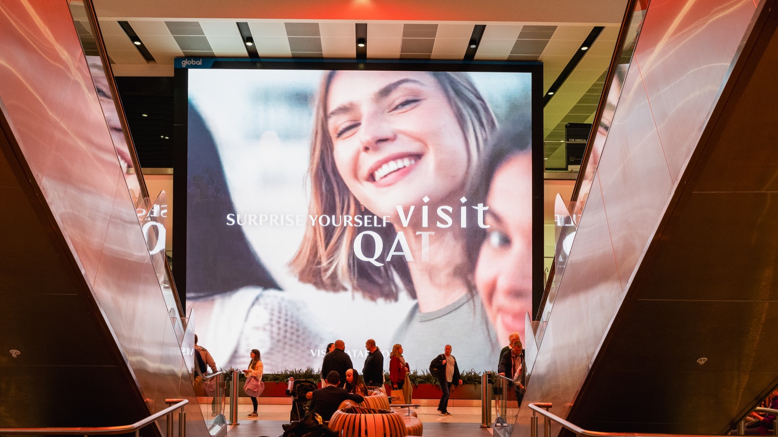 Large format digital advertising screen in an airport departure lounge